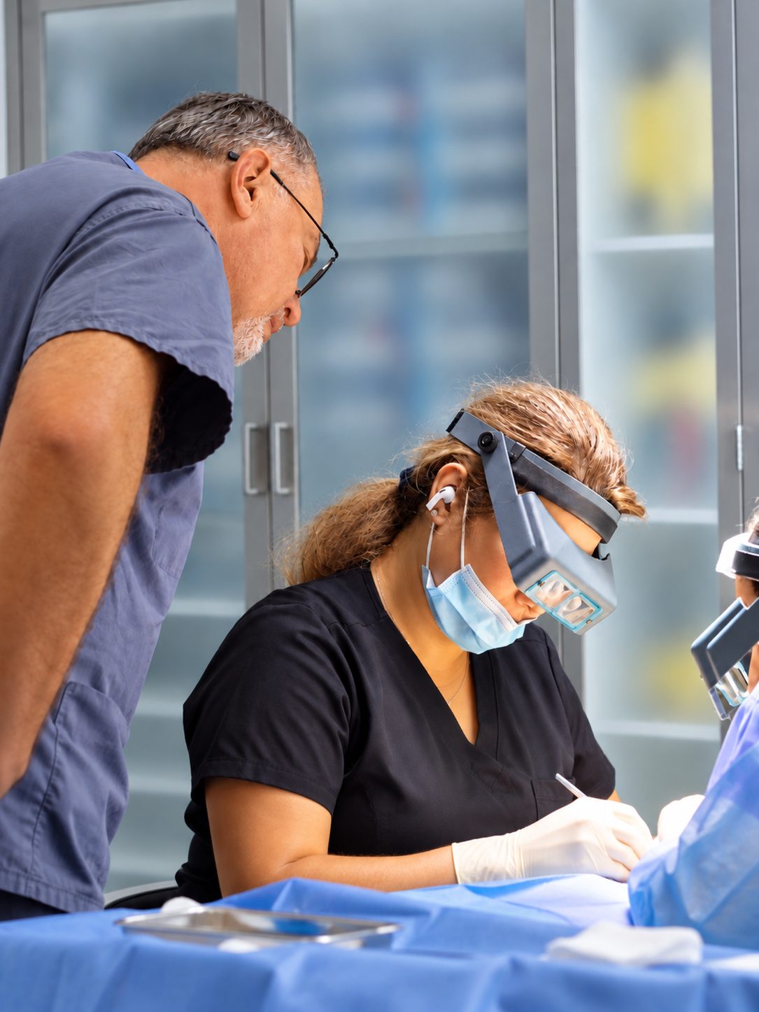 Hair restoration procedure overseen by Dr. Val Prokurat, MD, with a technician using magnifying loupes at Nova Medical Philadelphia in Old City